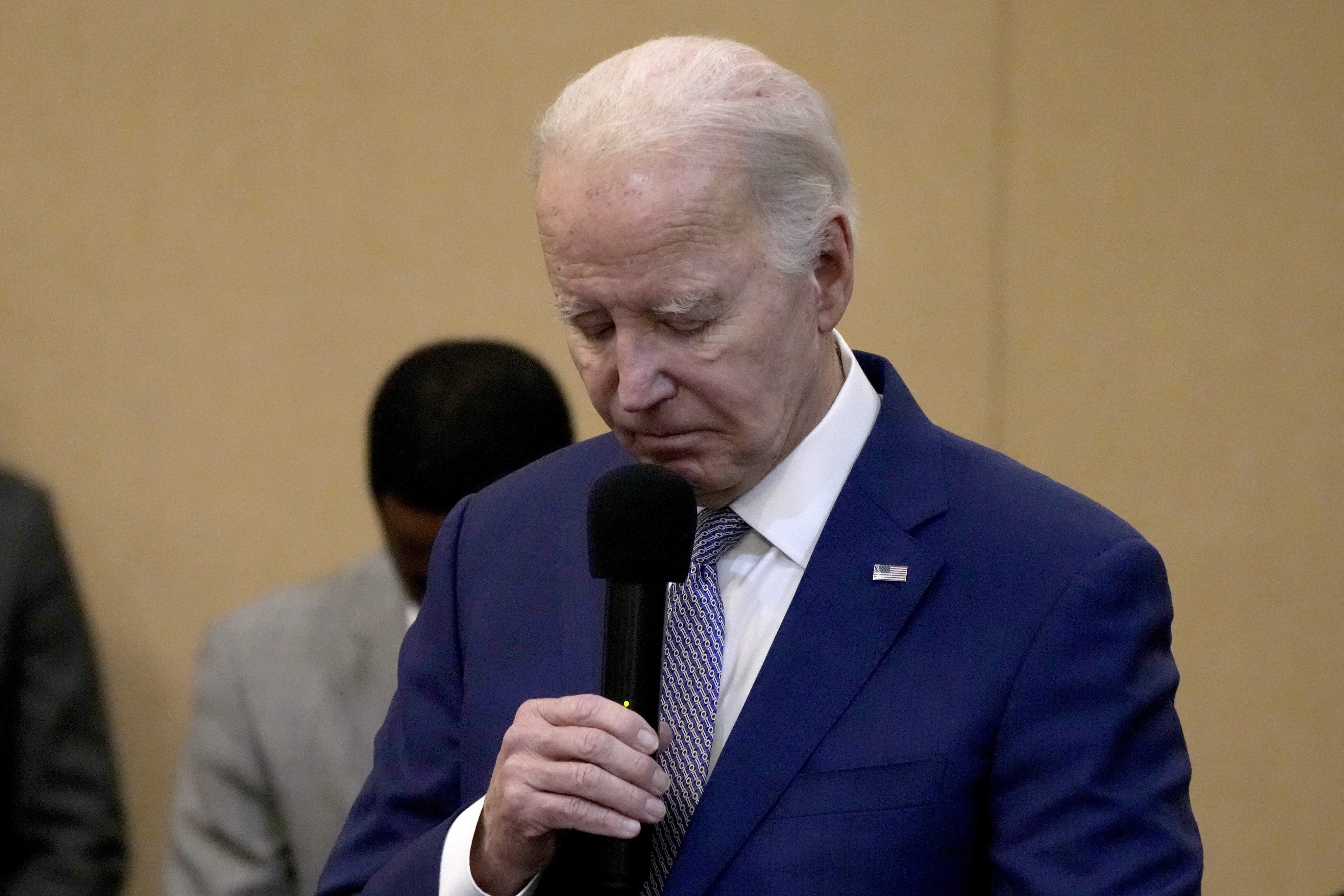 Joe Biden bows his head in a moment of silence for the three American troops killed